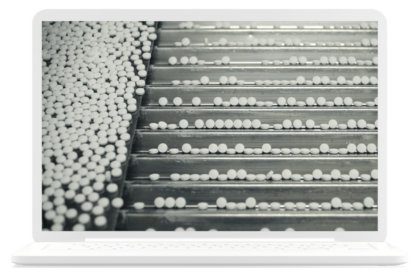 White pills in the manufacturing process.